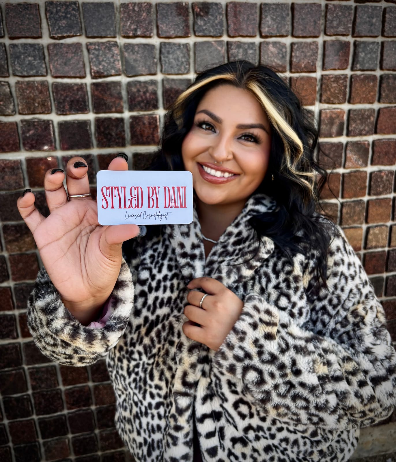 Dani, owner and licensed cosmetologist at Styled By Dani, in a leopard-print coat